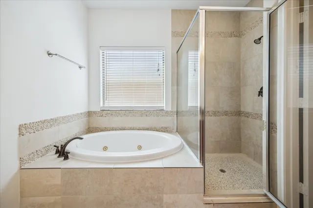 a bathroom with a tub and a shower
