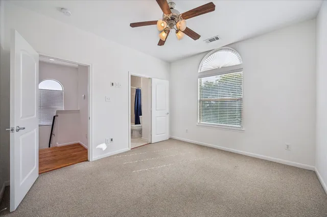 a bathroom with a granite countertop sink a mirror a bathtub and shower