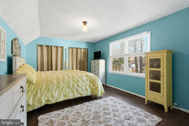 a bed sitting in a bedroom next to a window