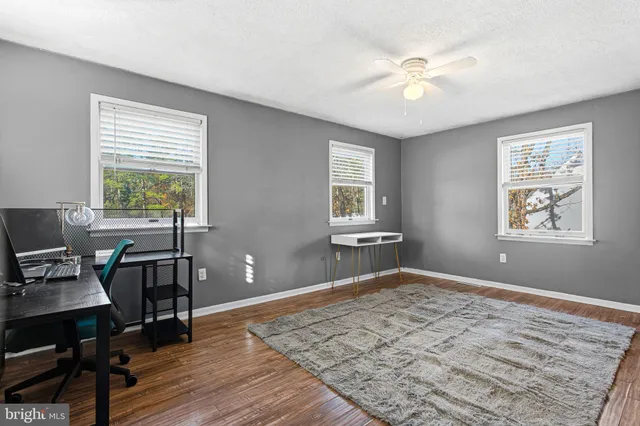 a view of a workspace with furniture and a window
