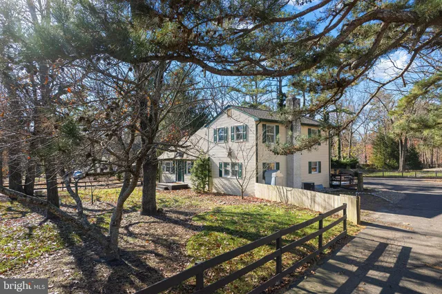 a view of a white house with a yard