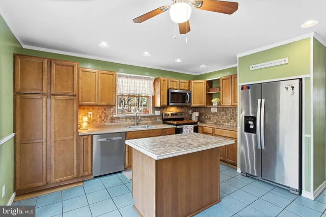 a kitchen with a refrigerator a sink and cabinets