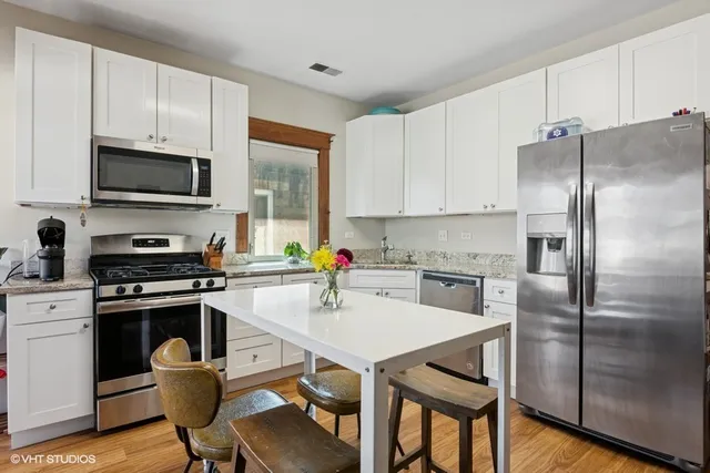 a kitchen with cabinets stainless steel appliances and a counter space