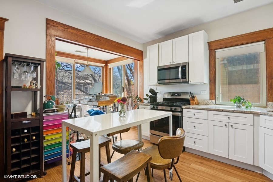 7227 Jackson Boulevard, Unit 2 Forest Park, IL 60130 - Photo 4 of 6 a kitchen with a stove a sink and a refrigerator