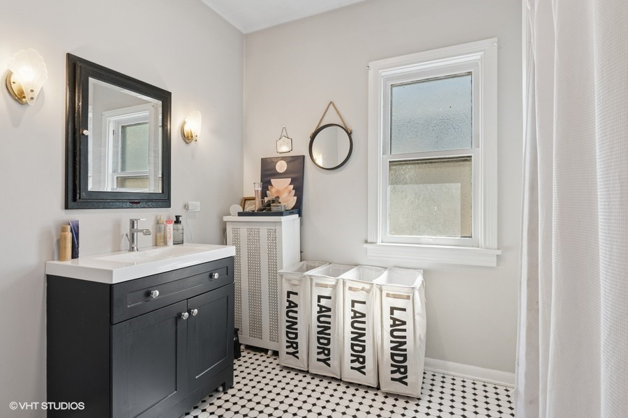 7227 Jackson Boulevard, Unit 2 Forest Park, IL 60130 - Photo 6 of 6 a bathroom with a sink a vanity and a mirror