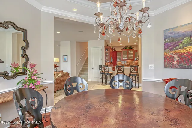 a spacious bedroom with a bed and a chandelier