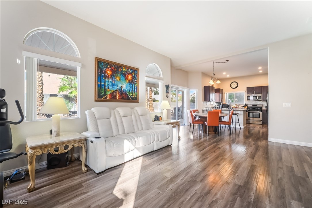 1081 Deep Well Court Henderson, NV 89011 - Photo 18 of 44 Living room with dark wood-type flooring and baseboards