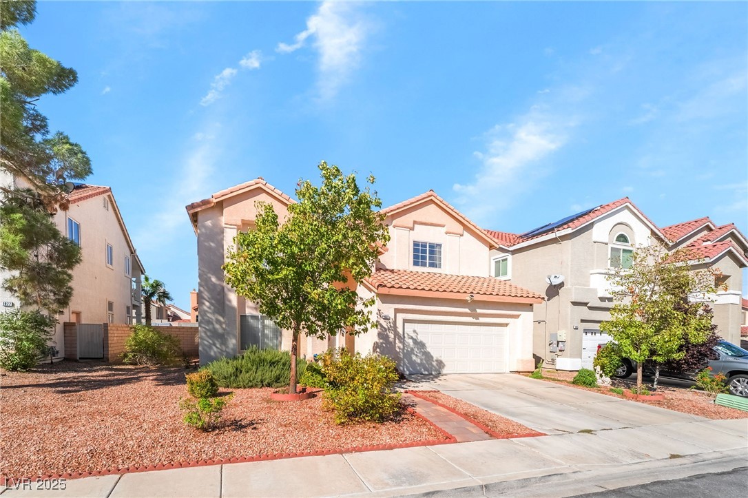 1081 Deep Well Court Henderson, NV 89011 - Photo 3 of 44 Mediterranean / spanish-style house with concrete driveway, a tile roof, stucco siding, and an attached garage