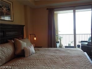 2743 First Street, Unit 1504 Fort Myers, FL 33916 - Photo 12 of 40 a bedroom with a bed and a large window