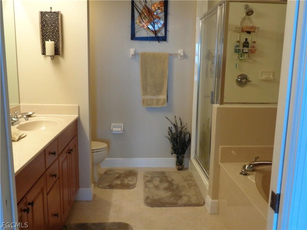 2743 First Street, Unit 1504 Fort Myers, FL 33916 - Photo 15 of 40 a bathroom with a granite countertop sink a toilet and shower