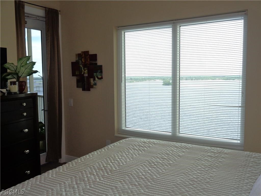 2743 First Street, Unit 1504 Fort Myers, FL 33916 - Photo 16 of 40 a bedroom with a bed and a window