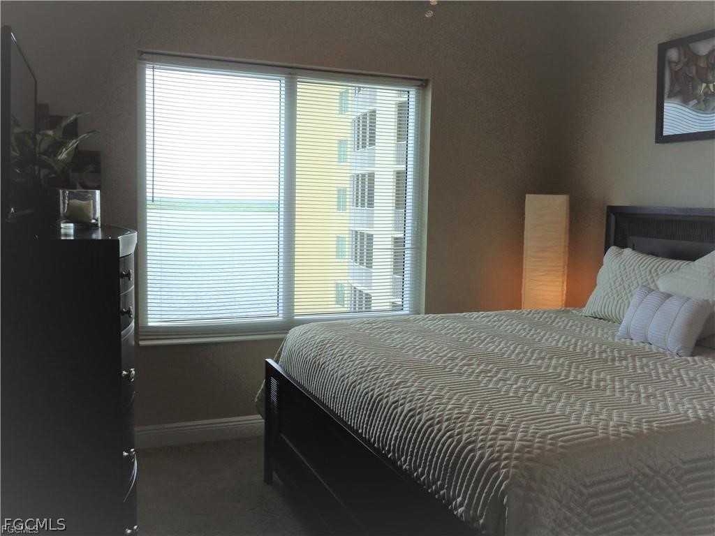 2743 First Street, Unit 1504 Fort Myers, FL 33916 - Photo 17 of 40 a bedroom with a bed and a window