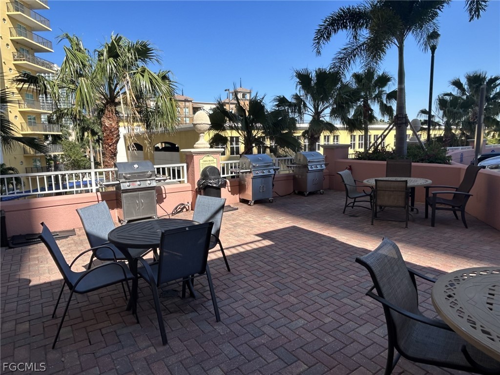 2743 First Street, Unit 1504 Fort Myers, FL 33916 - Photo 24 of 40 a dining room with furniture and a palm tree