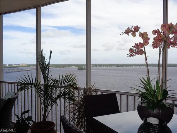 a living room with furniture and a dining table