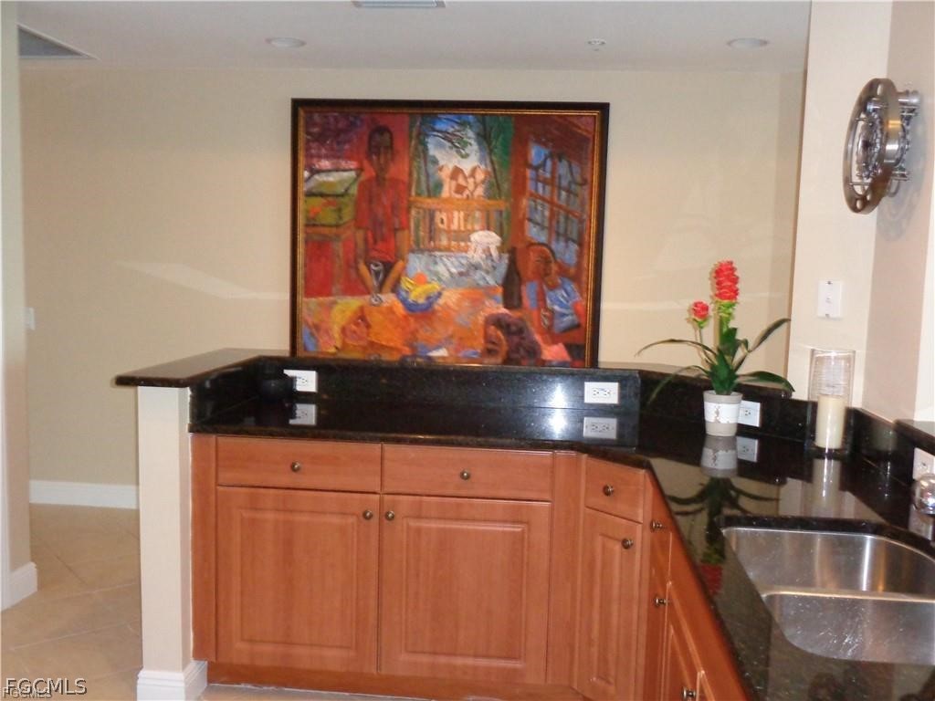 2743 First Street, Unit 1504 Fort Myers, FL 33916 - Photo 9 of 40 a kitchen with a sink a microwave and cabinets