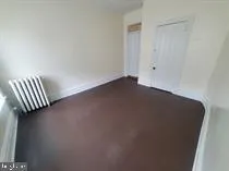 an empty room with a bench