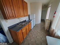 1335 Perkiomen Avenue, Unit 9 Reading, PA 19602 - Photo 5 of 8 a view of a kitchen with wooden floor and staircase