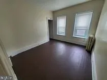 a view of room with window and hardwood floor