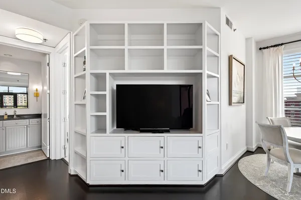 a living room with a fireplace and a flat screen tv