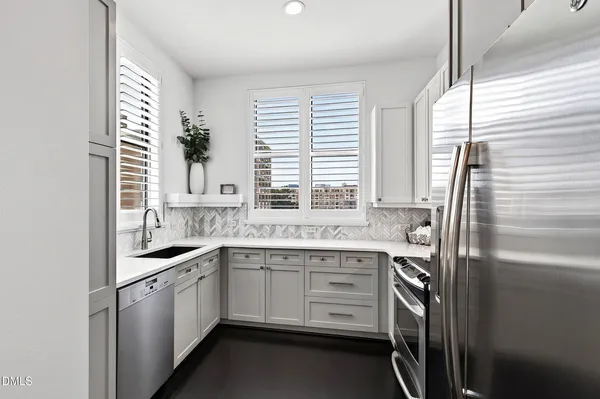 a kitchen with appliances cabinets and a window