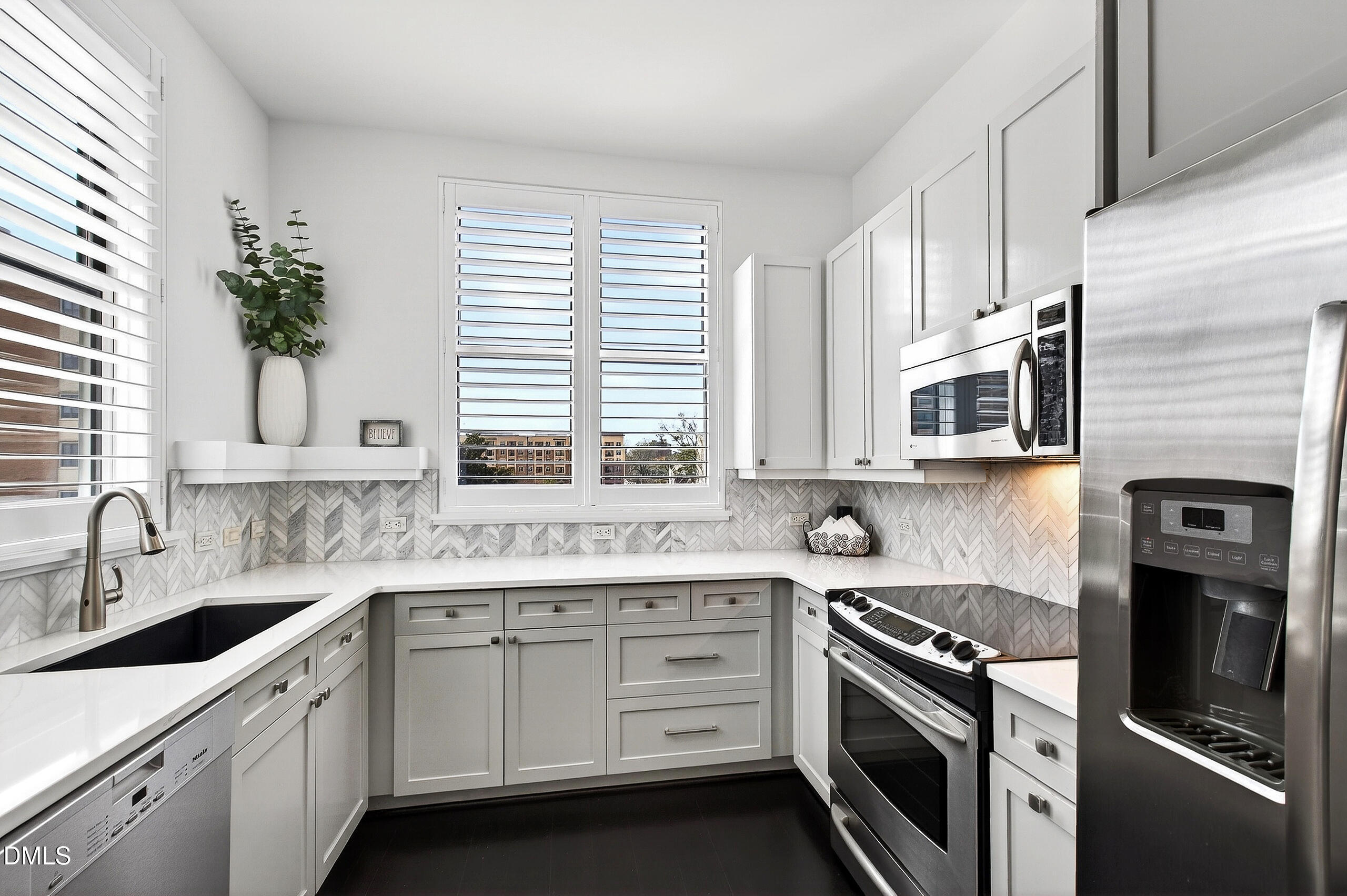 618 North Boylan Avenue, Unit 506 Raleigh, NC 27603 - Photo 18 of 71 a kitchen with stainless steel appliances white cabinets and a stove top oven