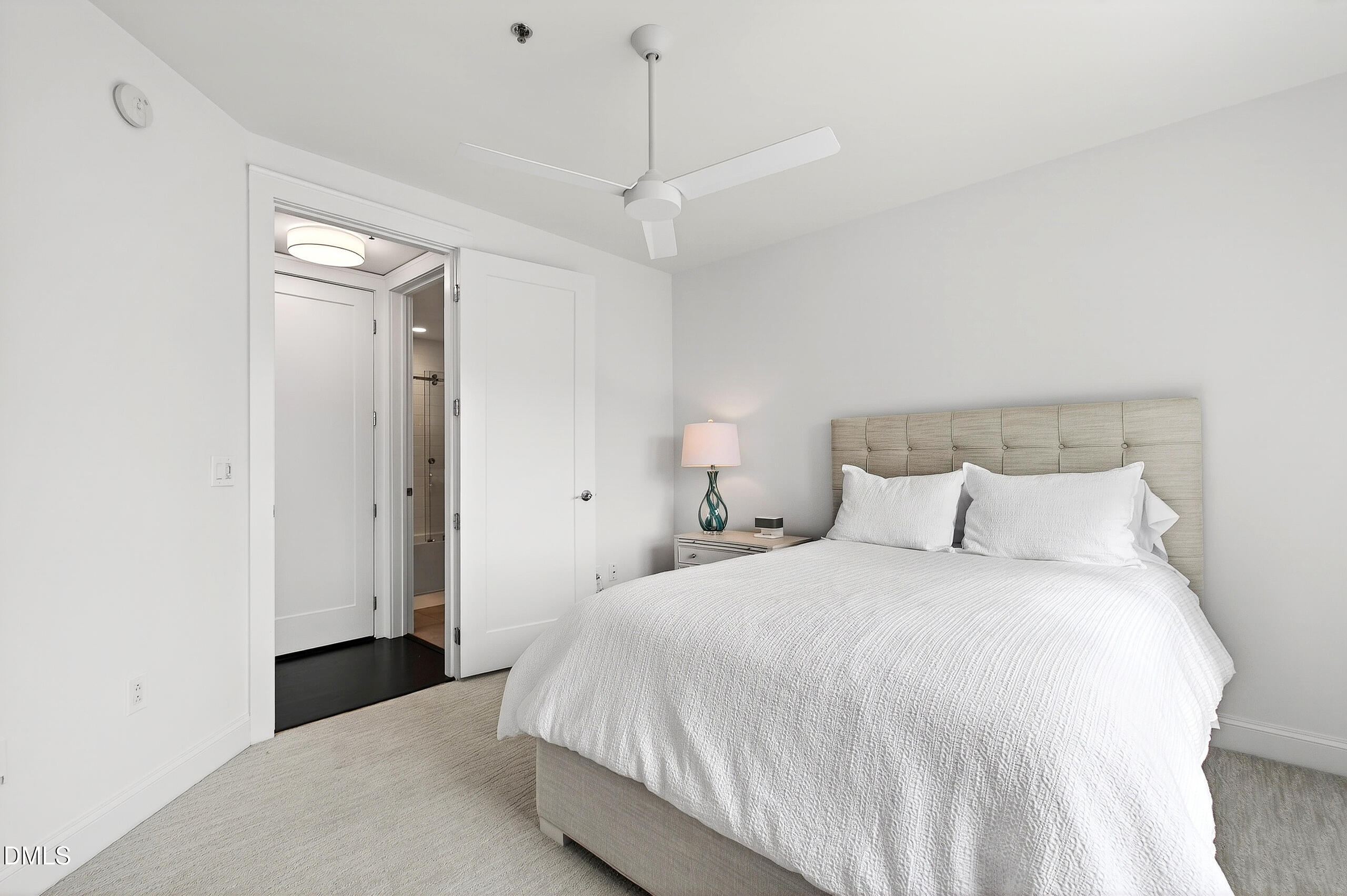 618 North Boylan Avenue, Unit 506 Raleigh, NC 27603 - Photo 30 of 71 a bedroom with a bed and a chandelier