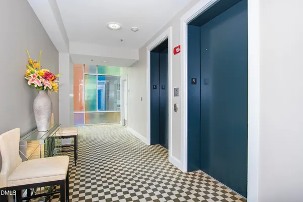 a view of a building with garden and sitting area