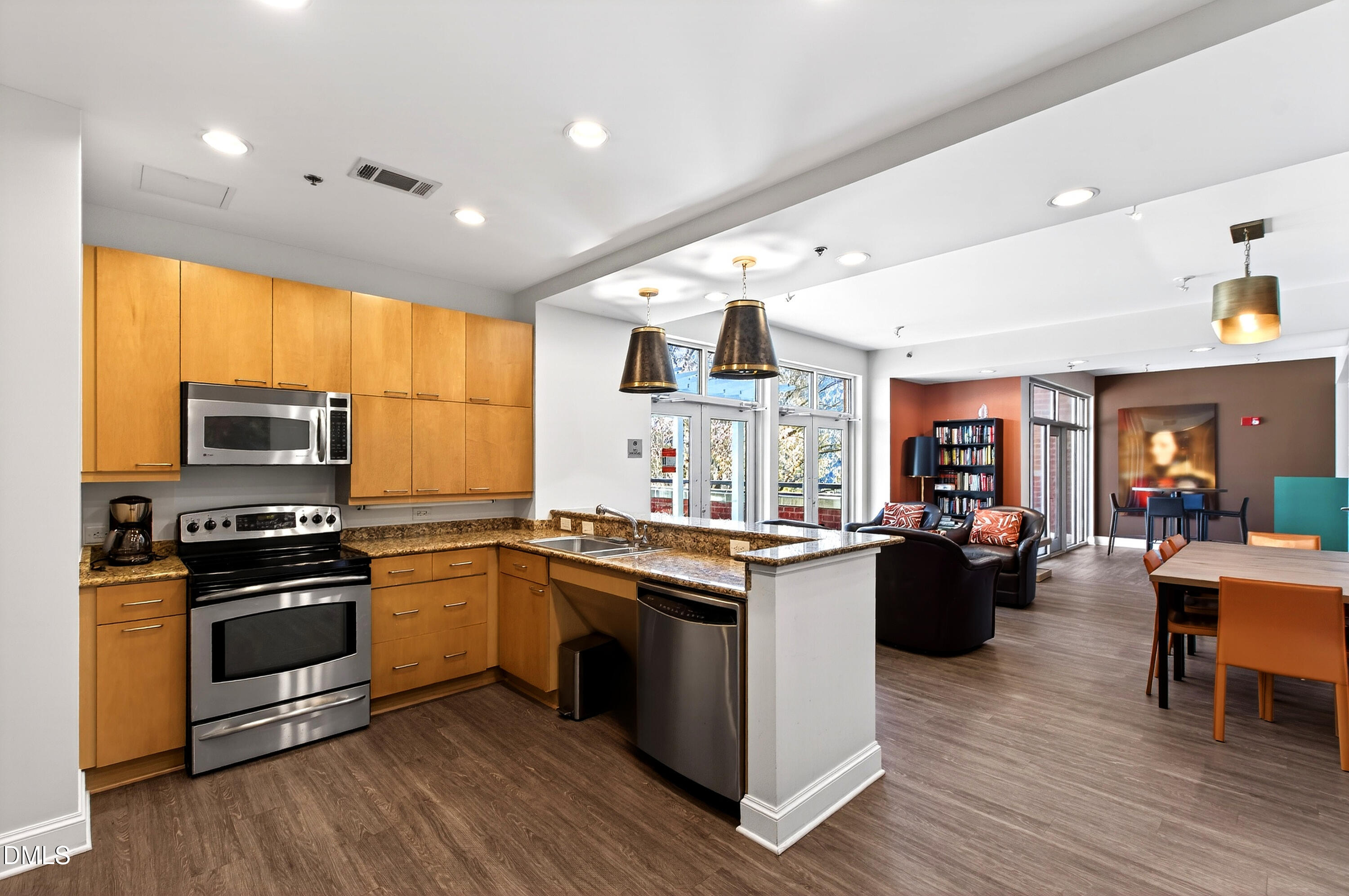 618 North Boylan Avenue, Unit 506 Raleigh, NC 27603 - Photo 47 of 71 a kitchen with stainless steel appliances granite countertop a stove top oven a sink dishwasher a refrigerator and cabinets with wooden floor