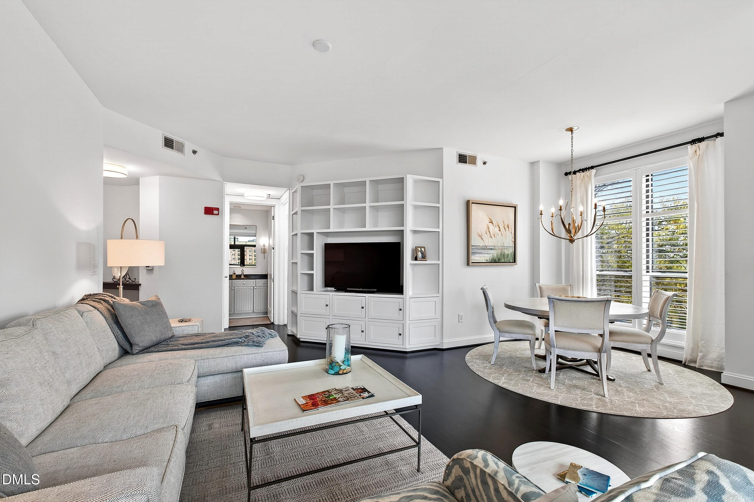 618 North Boylan Avenue, Unit 506 Raleigh, NC 27603 - Photo 4 of 71 a living room with furniture a flat screen tv and a large window