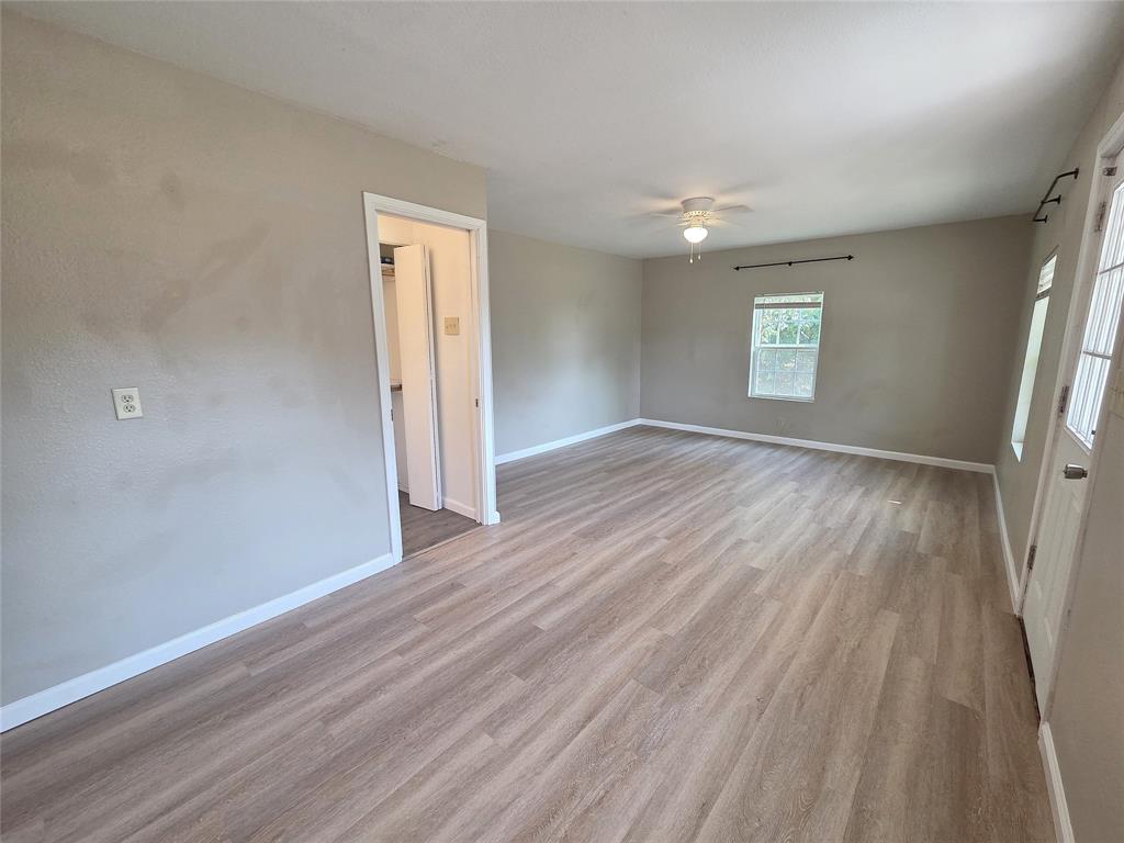 1901 Highway 276, Unit 4 West Tawakoni, TX 75474 - Photo 11 of 11 an empty room with wooden floor and windows
