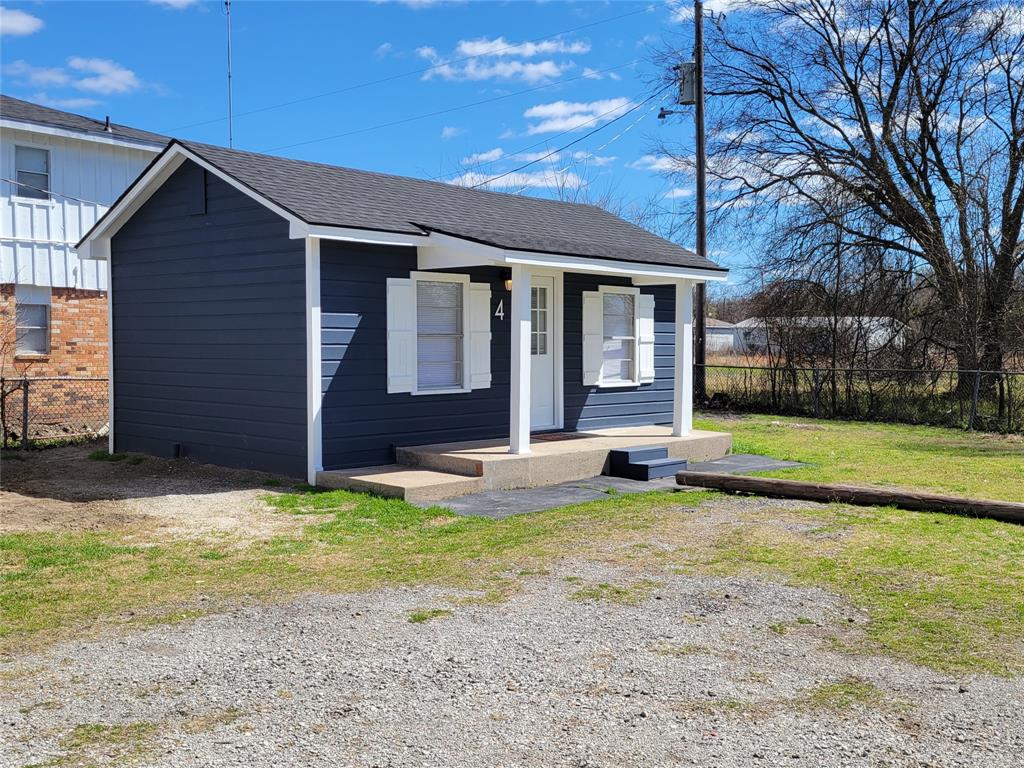1901 Highway 276, Unit 4 West Tawakoni, TX 75474 - Photo 4 of 11 a view of a house with a yard patio and a floor to ceiling window