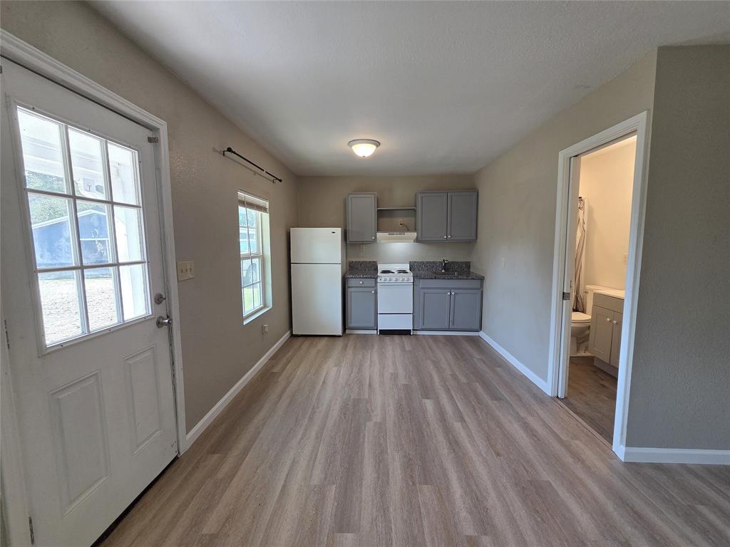 1901 Highway 276, Unit 4 West Tawakoni, TX 75474 - Photo 6 of 11 a view of kitchen and wooden floor