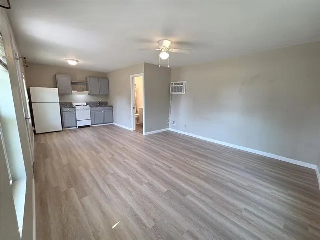 a view of a livingroom with a furniture wooden floor and chandelier