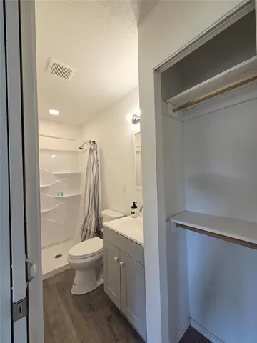 a bathroom with a shower a toilet and a sink