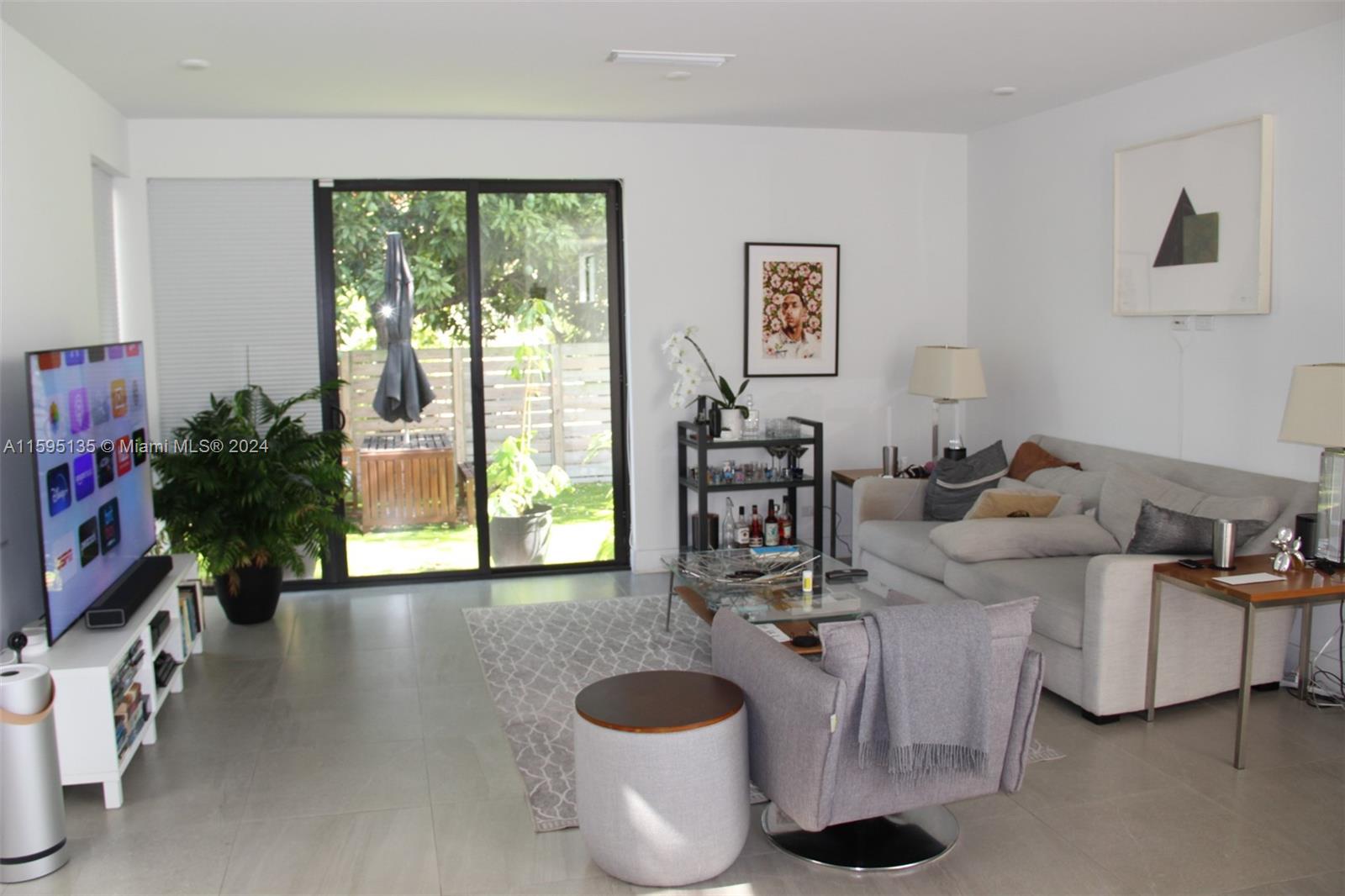 2944 Southwest 27th Terrace, Unit 2944 Miami, FL 33133 - Photo 1 of 44 a living room with furniture and a large window