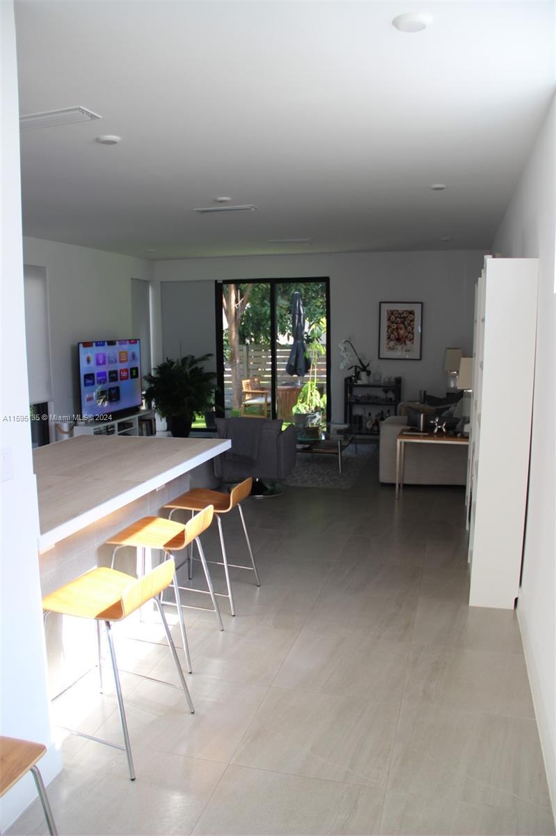 2944 Southwest 27th Terrace, Unit 2944 Miami, FL 33133 - Photo 11 of 44 a living room with furniture a window and a table