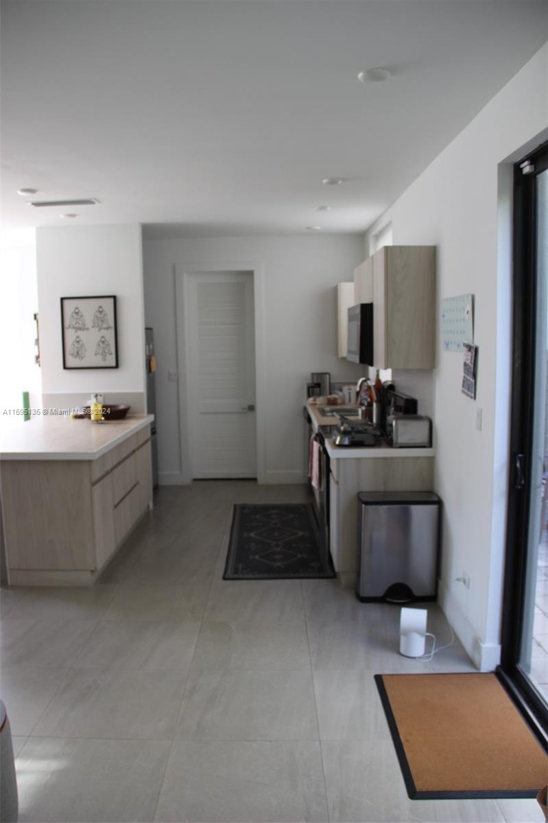 2944 Southwest 27th Terrace, Unit 2944 Miami, FL 33133 - Photo 12 of 44 a kitchen with a stove and a refrigerator