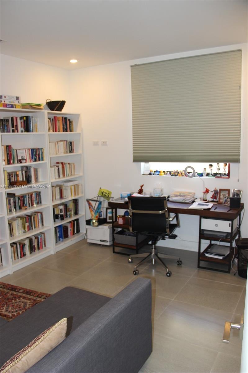 2944 Southwest 27th Terrace, Unit 2944 Miami, FL 33133 - Photo 20 of 44 a room with furniture and book shelf
