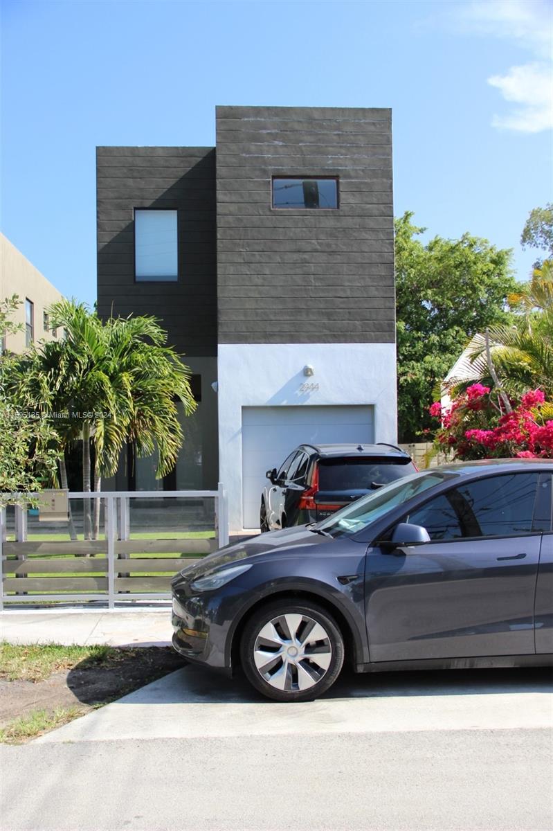 2944 Southwest 27th Terrace, Unit 2944 Miami, FL 33133 - Photo 2 of 44 a front view of a house with garden