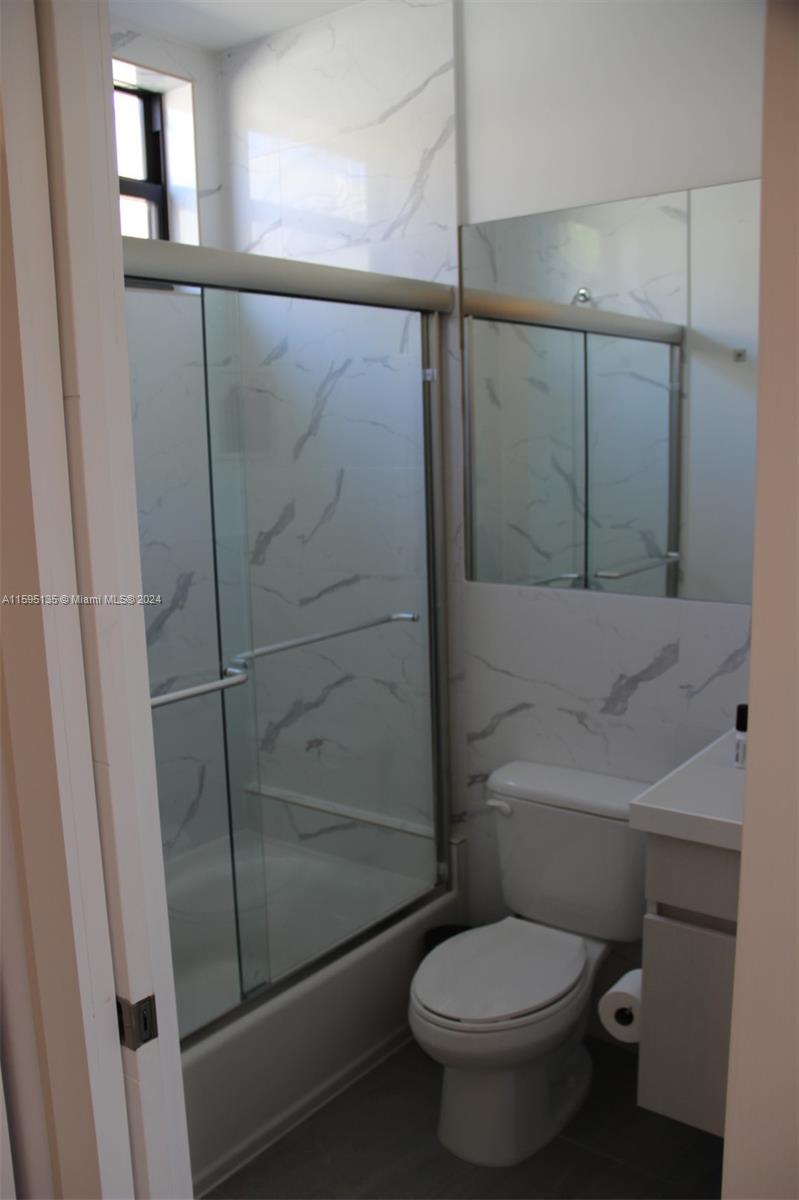 2944 Southwest 27th Terrace, Unit 2944 Miami, FL 33133 - Photo 22 of 44 a white toilet sitting next to a shower