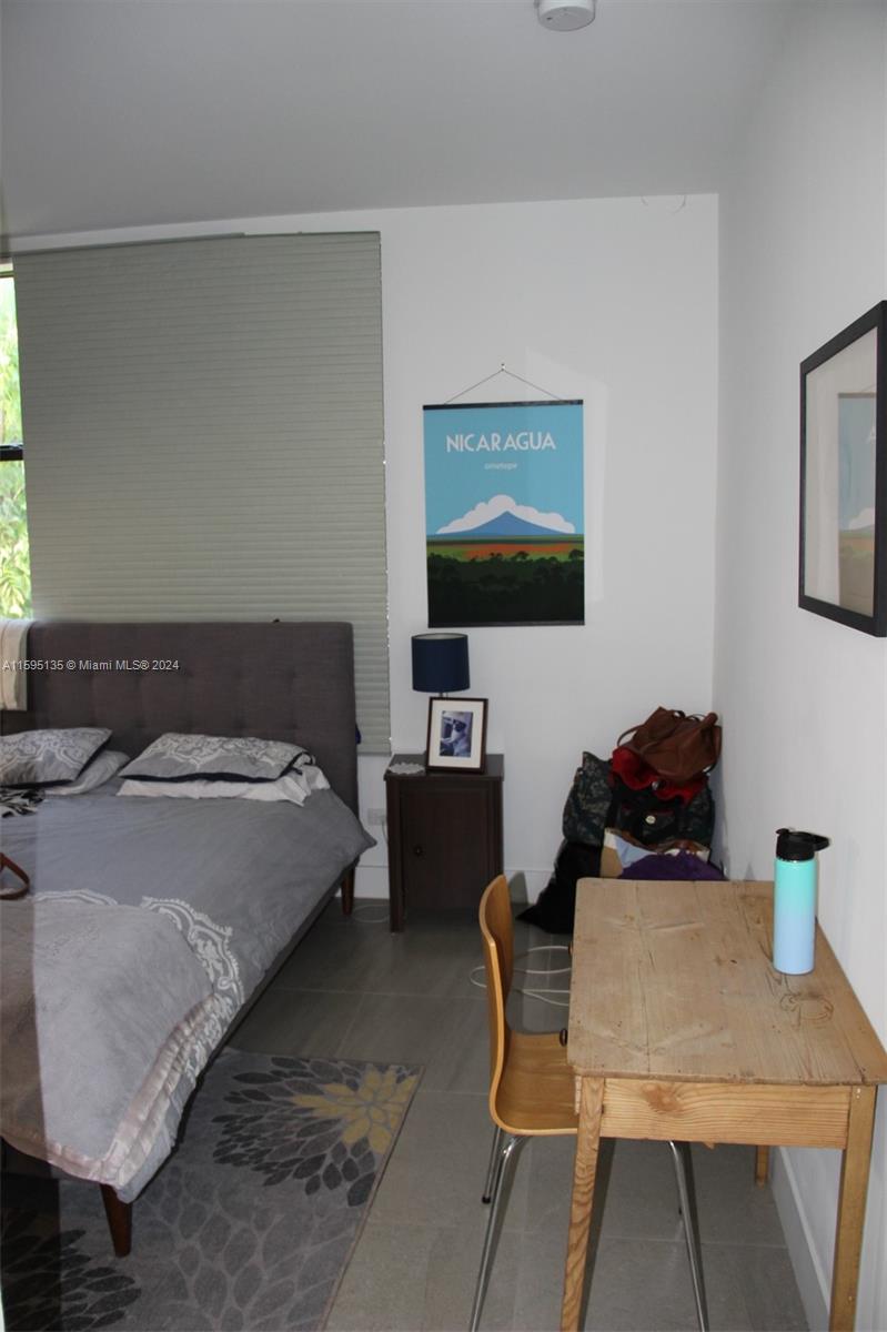 2944 Southwest 27th Terrace, Unit 2944 Miami, FL 33133 - Photo 25 of 44 a bedroom with a bed and a table in it
