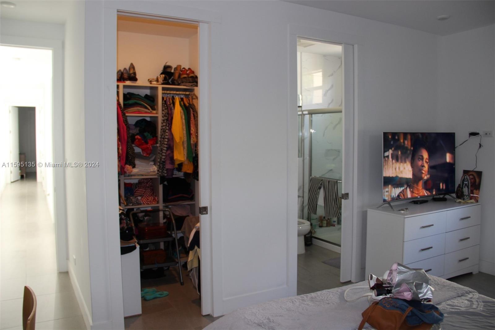 2944 Southwest 27th Terrace, Unit 2944 Miami, FL 33133 - Photo 27 of 44 a view of walk in closet with clothes and shoes