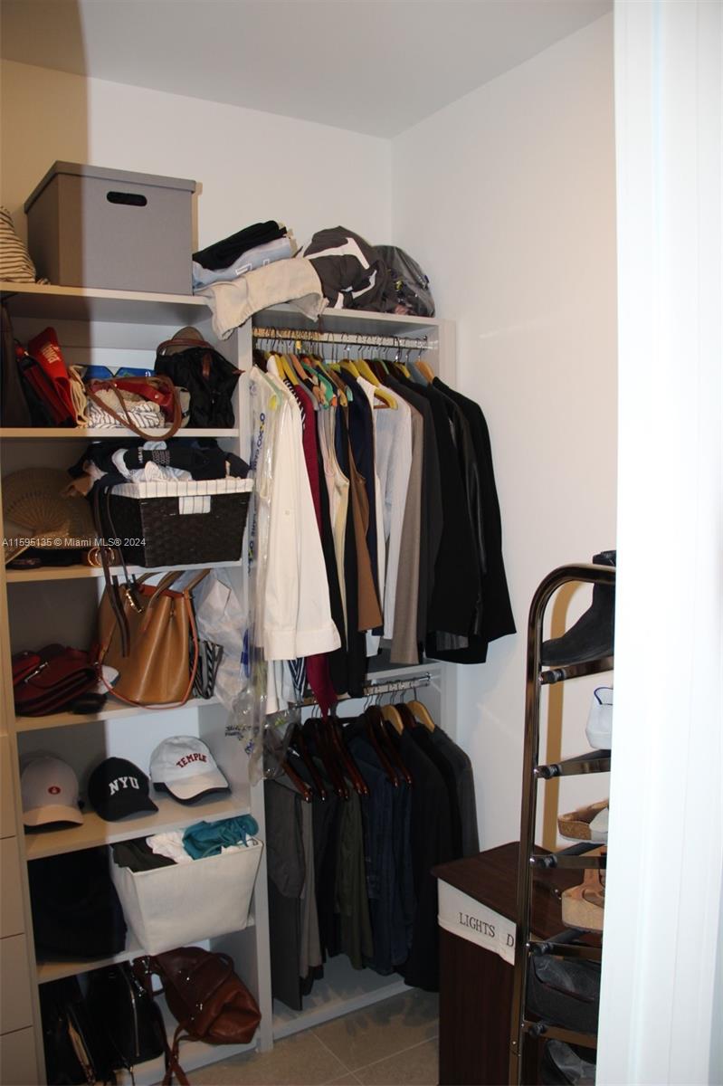 2944 Southwest 27th Terrace, Unit 2944 Miami, FL 33133 - Photo 30 of 44 a view of walk in closet with clothes and shoes