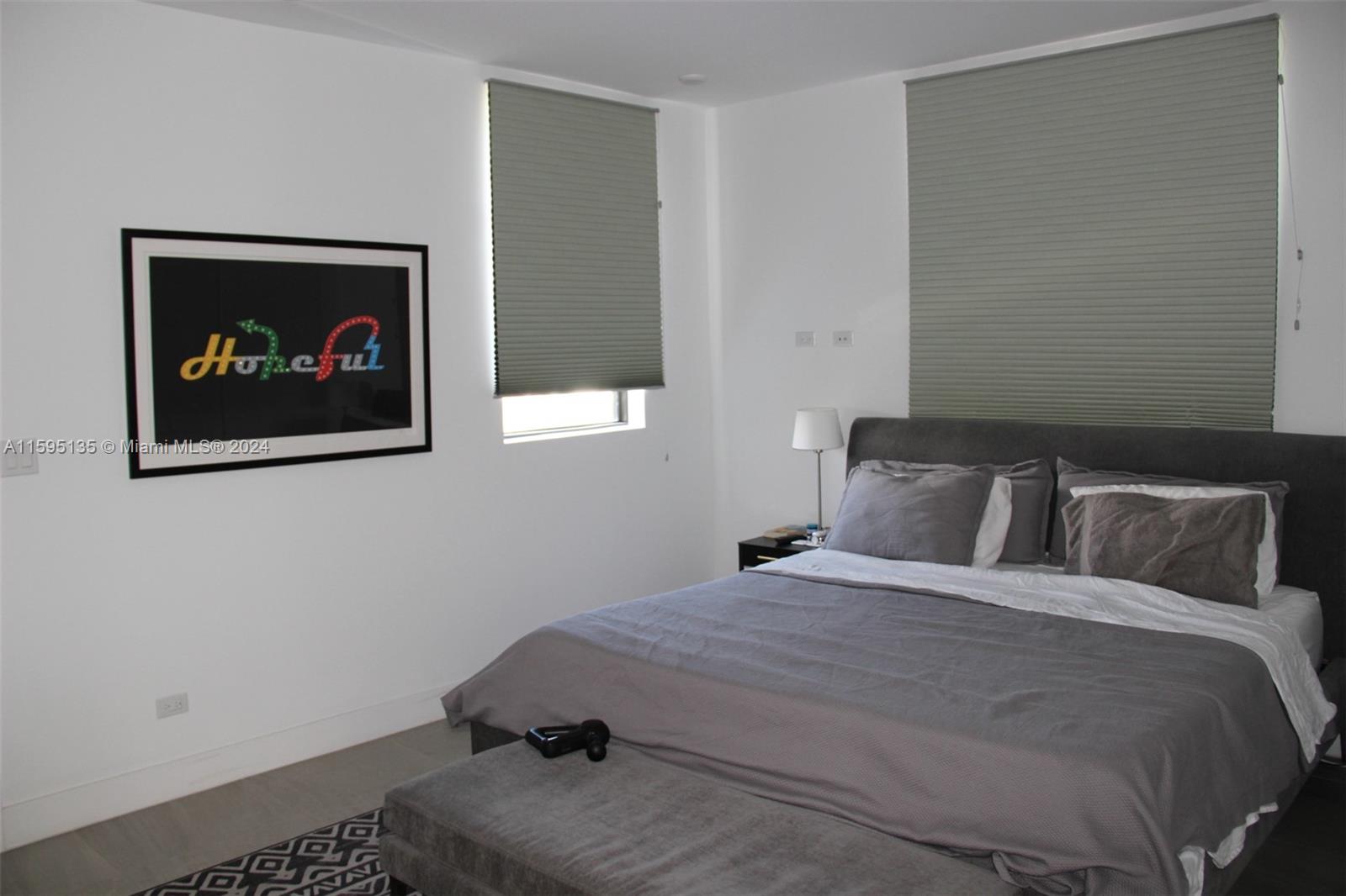 2944 Southwest 27th Terrace, Unit 2944 Miami, FL 33133 - Photo 31 of 44 a bedroom with a bed and a wall painting