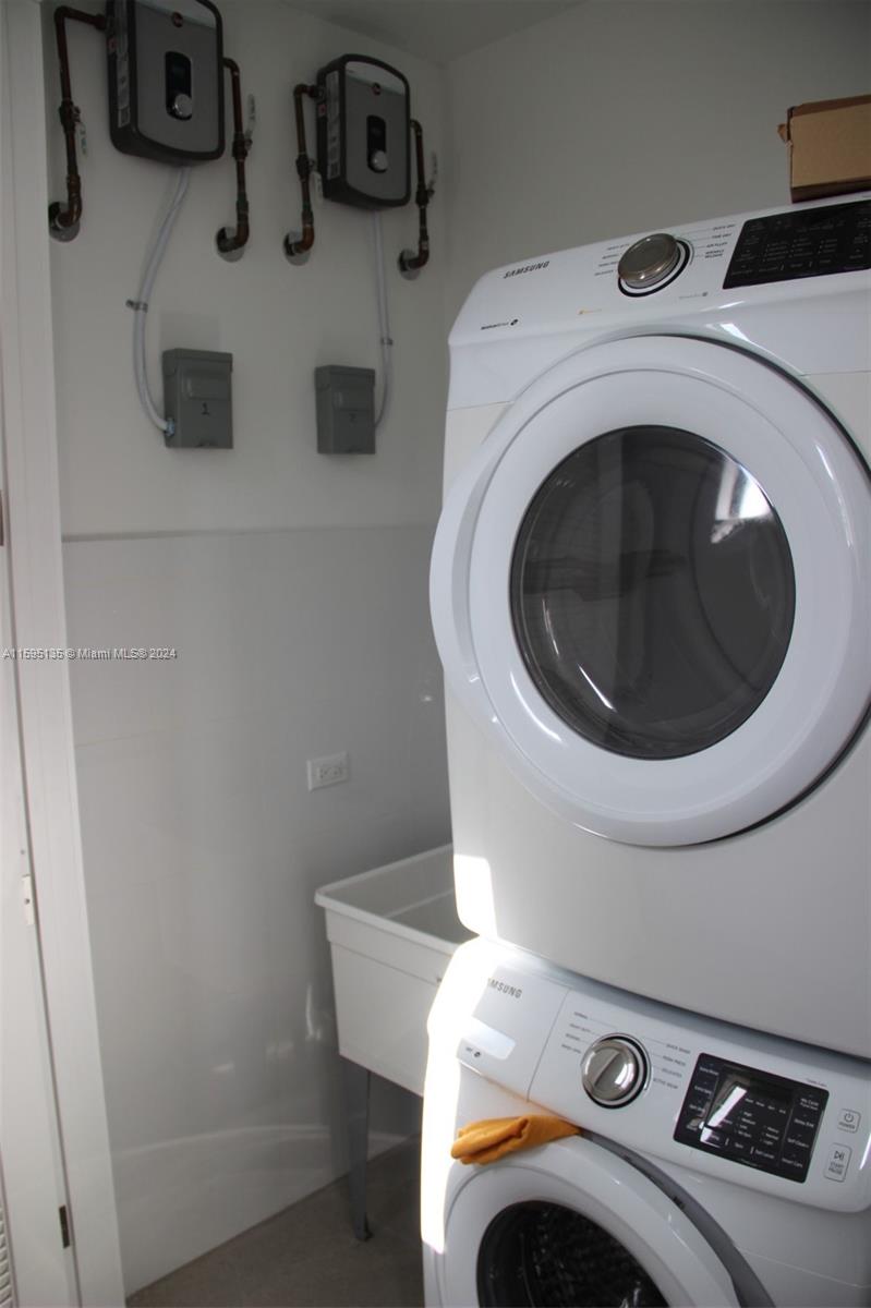 2944 Southwest 27th Terrace, Unit 2944 Miami, FL 33133 - Photo 33 of 44 a utility room with dryer and washer
