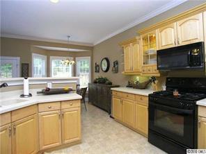 3527 Nestling Lane Fort Mill, SC 29708 - Photo 7 of 16 a kitchen with stainless steel appliances granite countertop a stove a sink and a microwave