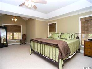 3527 Nestling Lane Fort Mill, SC 29708 - Photo 10 of 16 a bedroom with a bed and a chandelier