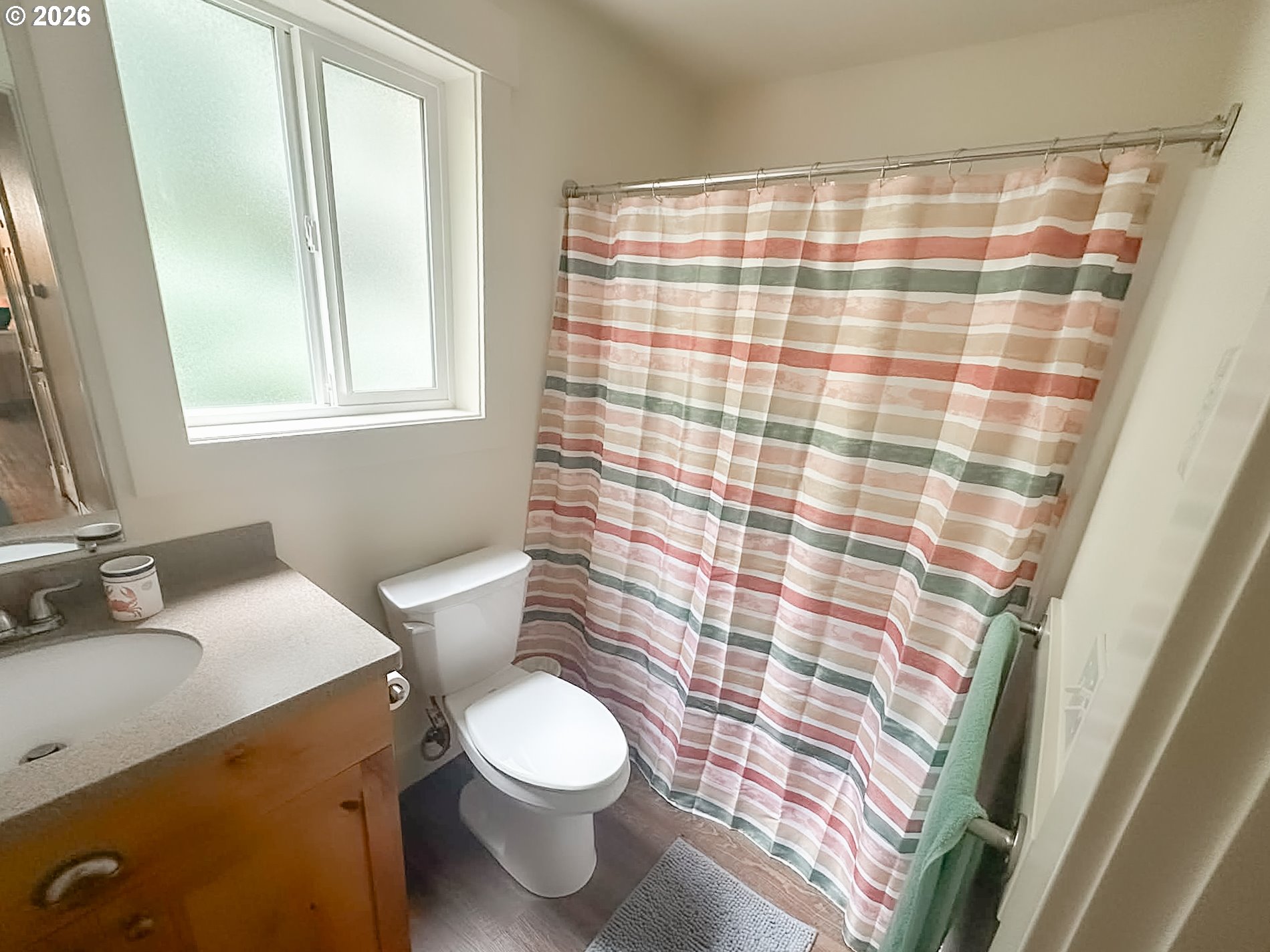 1601 Spruce Drive Seaside, OR 97138 - Photo 7 of 7 a bathroom with a sink a toilet and shower curtain