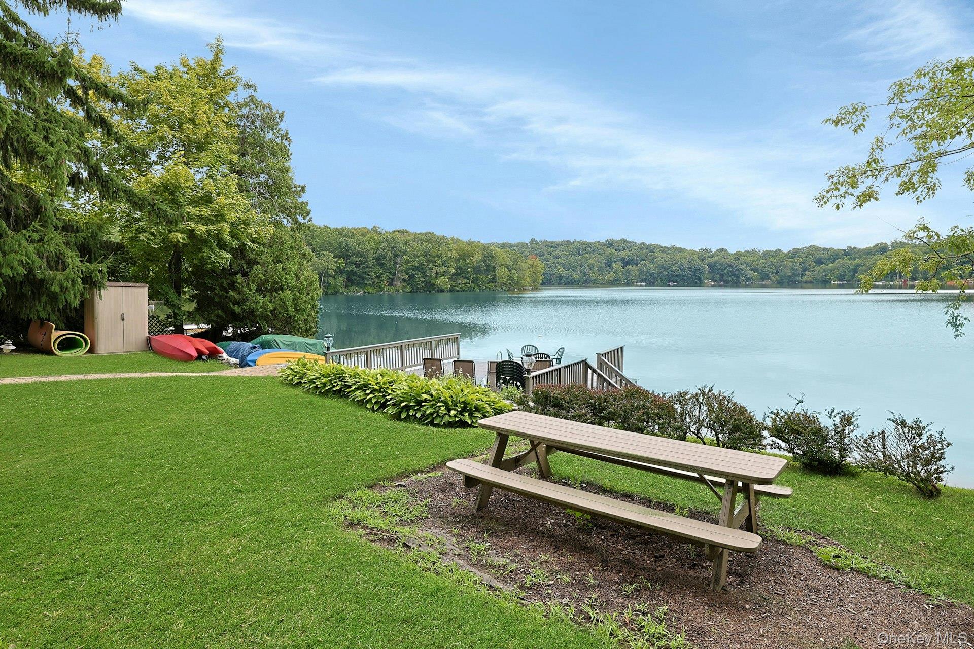 11 Lakeside Road Mahopac, NY 10541 - Photo 46 of 48 Enjoy outdoor dining by the water's edge, where peaceful lake views create the perfect backdrop. The few neighboring homes are set back, with no one to block any part of your view.