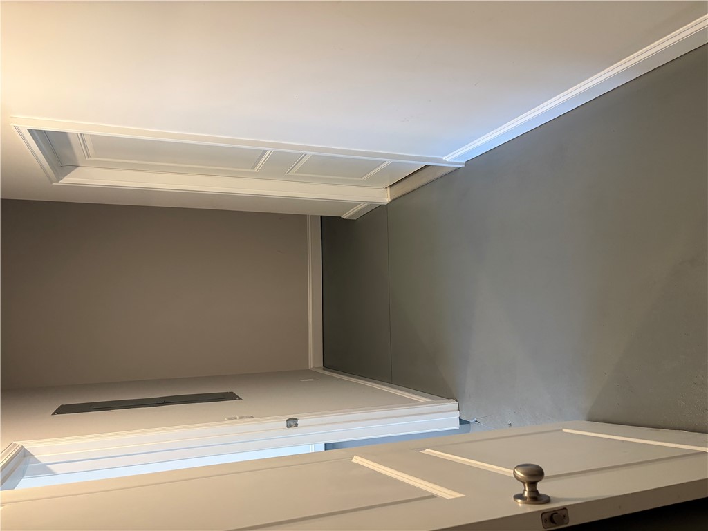 240 Meridian Way Seneca, SC 29672 - Photo 17 of 19 An attic access panel blends seamlessly with elegant crown molding, a hallmark of detailed craftsmanship.